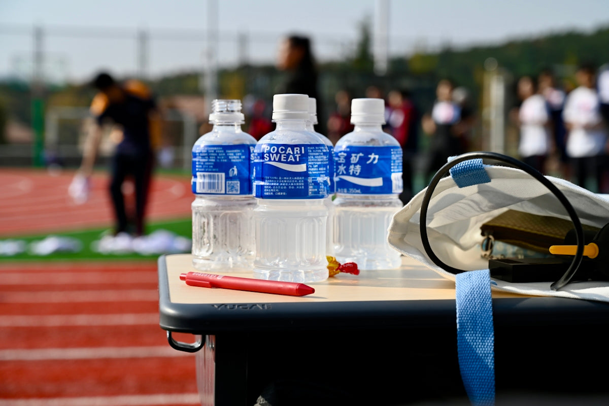 a table with a helmet and bottles of water on it