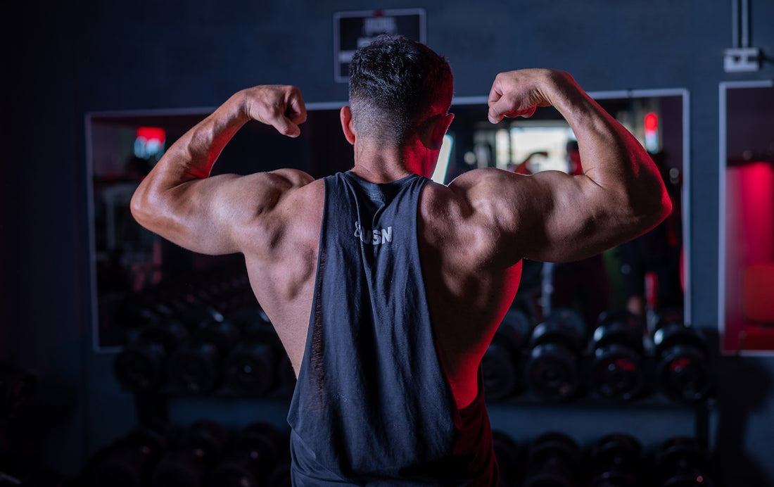 A man flexing his muscles in a gym