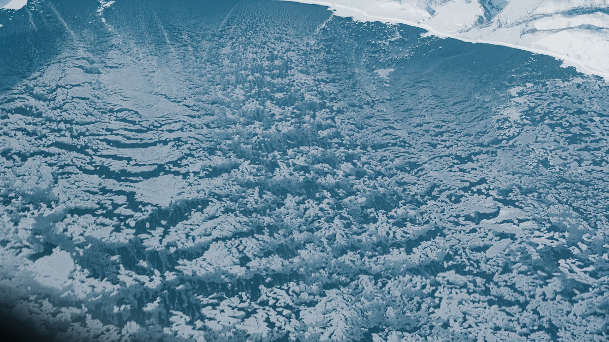 Here's a short caption: ice floes cover a vast, icy ocean.